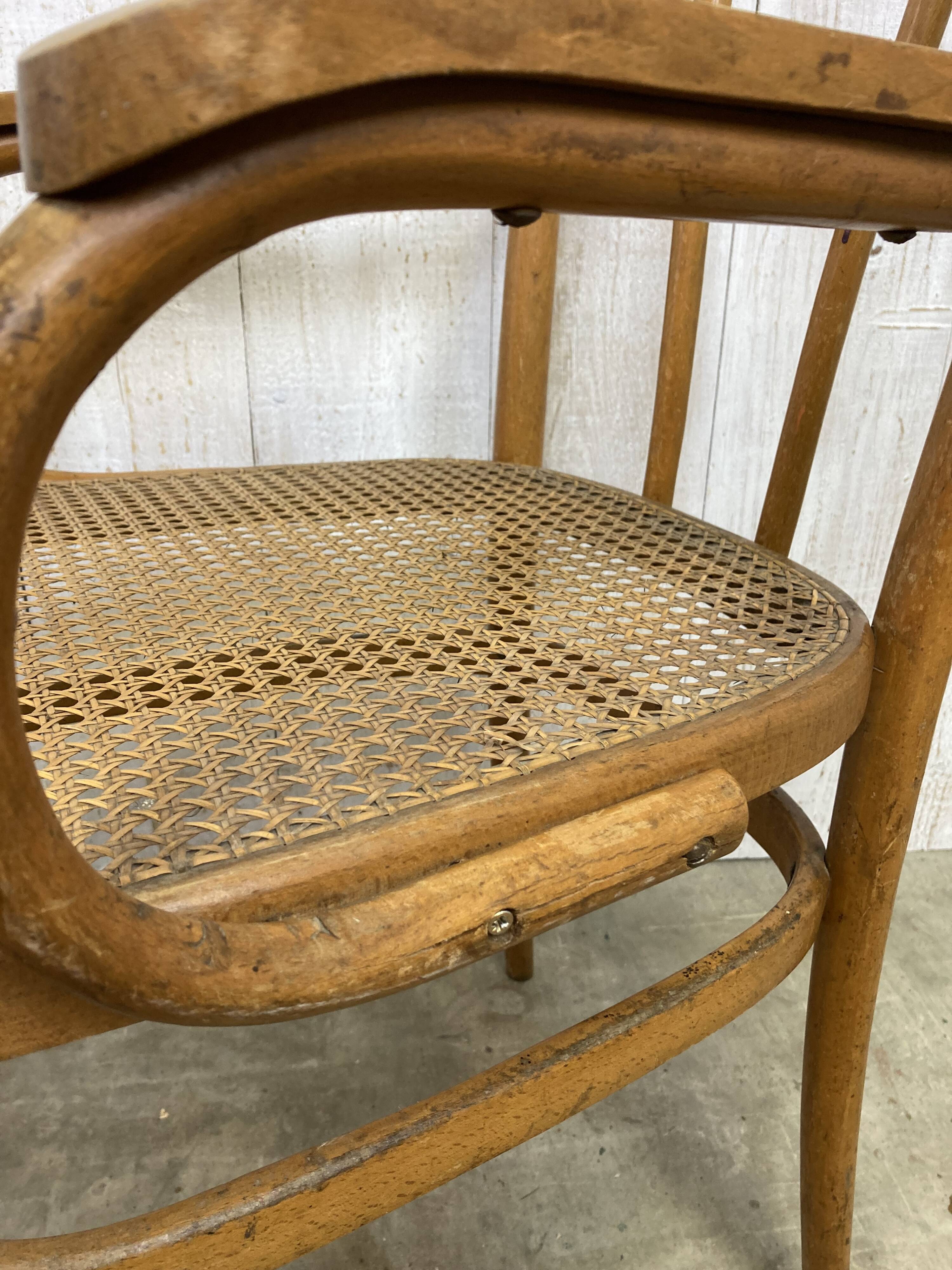 Curved wood and cane armchair