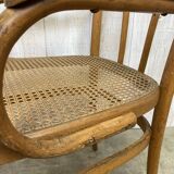 Curved wood and cane armchair