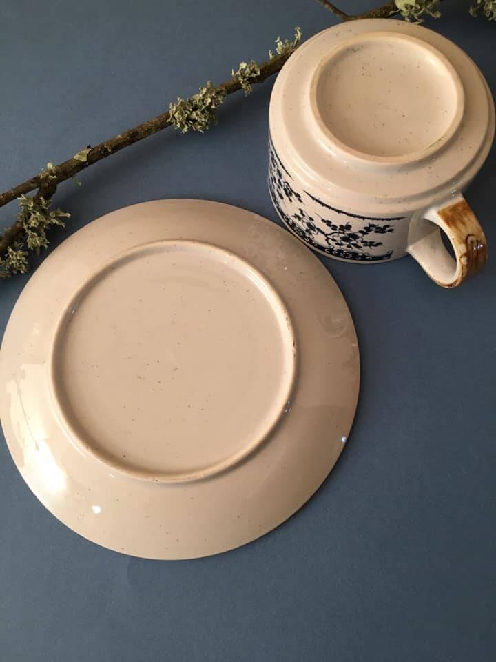 Large stoneware cup and saucer with delicate floral patterns