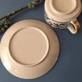 Large stoneware cup and saucer with delicate floral patterns
