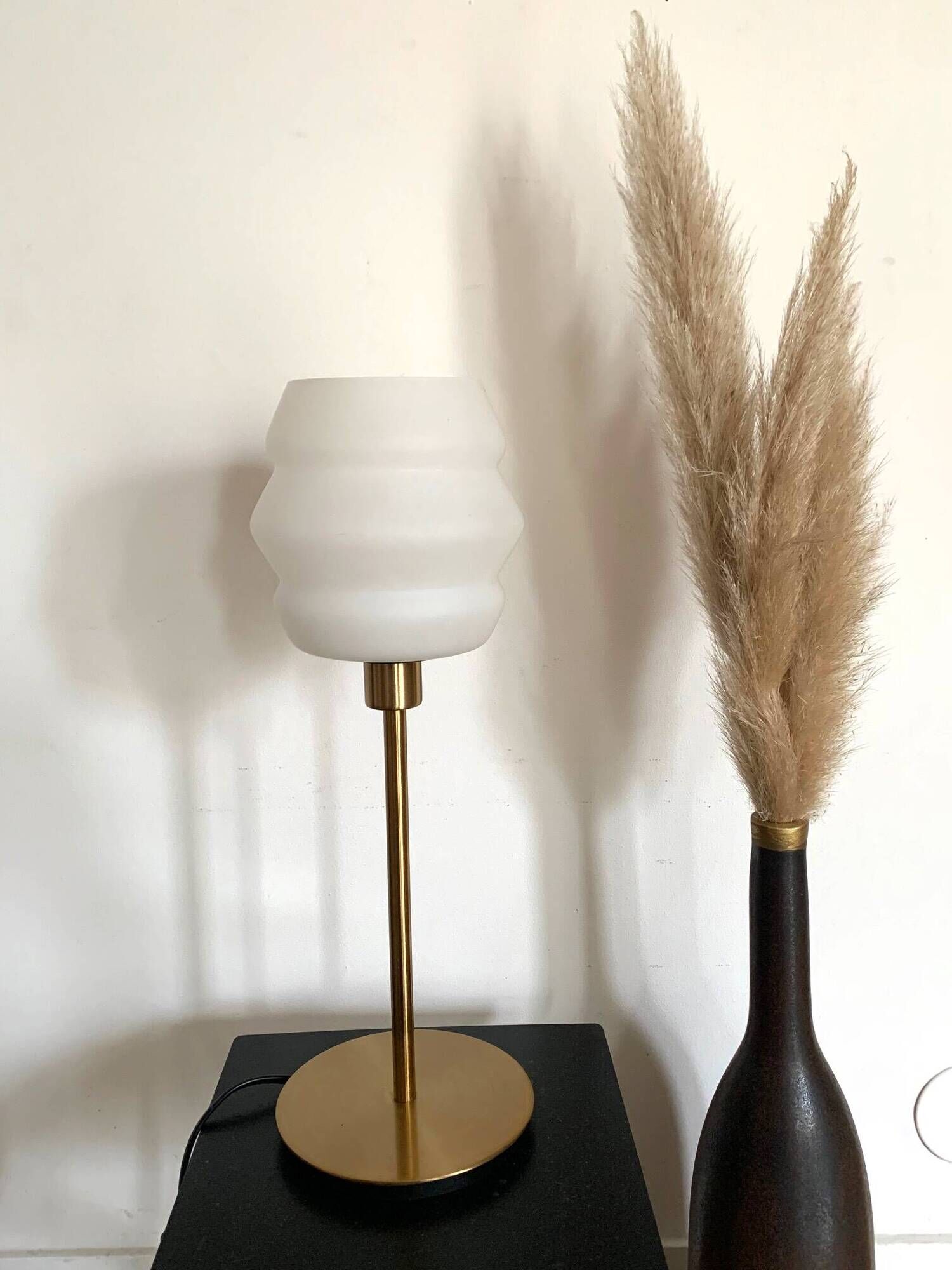 Table lamp with a vintage white glass globe and a golden base