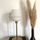 Table lamp with a vintage white glass globe and a golden base