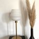 Table lamp with a vintage white glass globe and a golden base