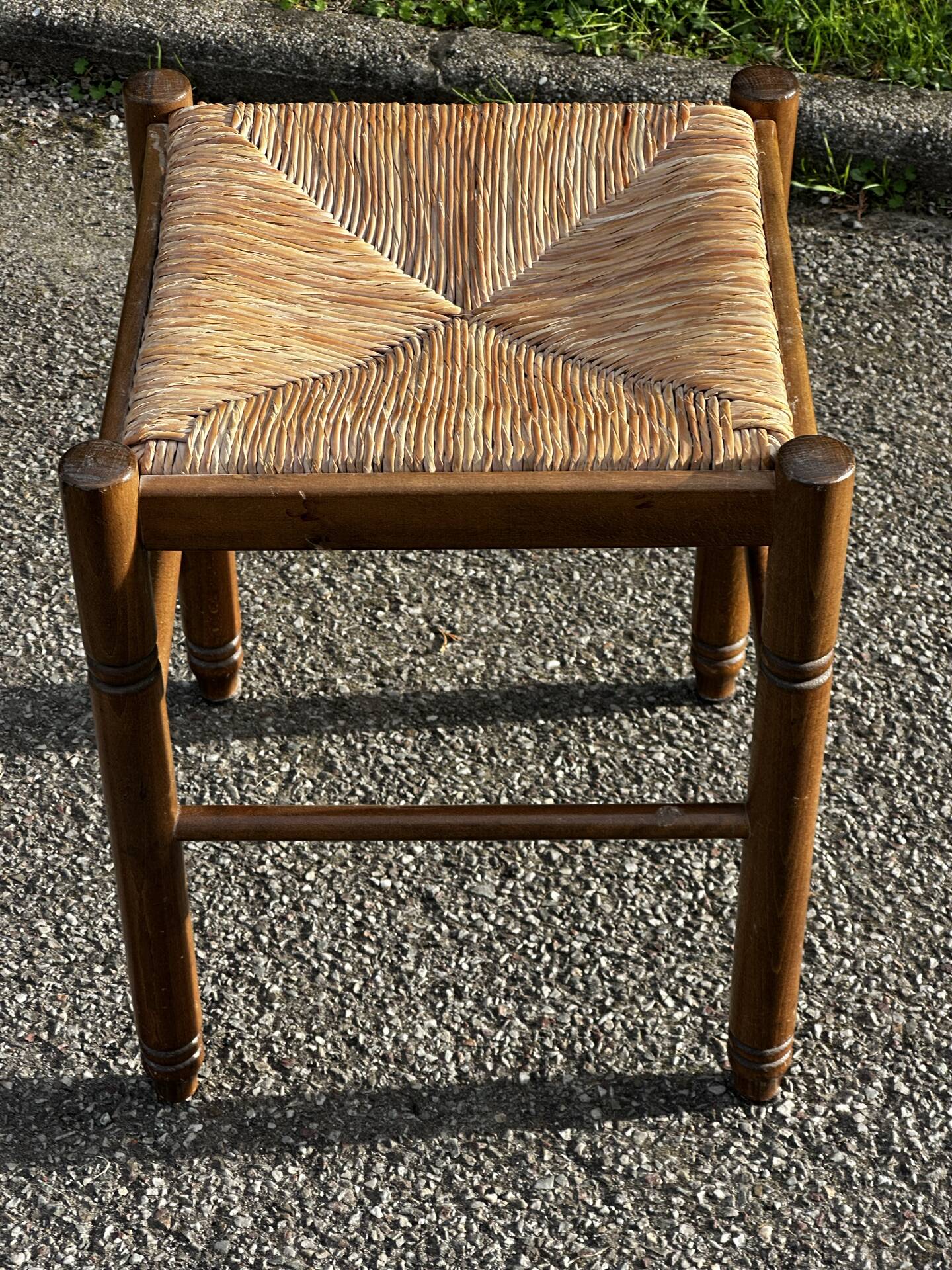 1950s turned wooden stool with a straw seat.