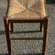 1950s turned wooden stool with a straw seat.