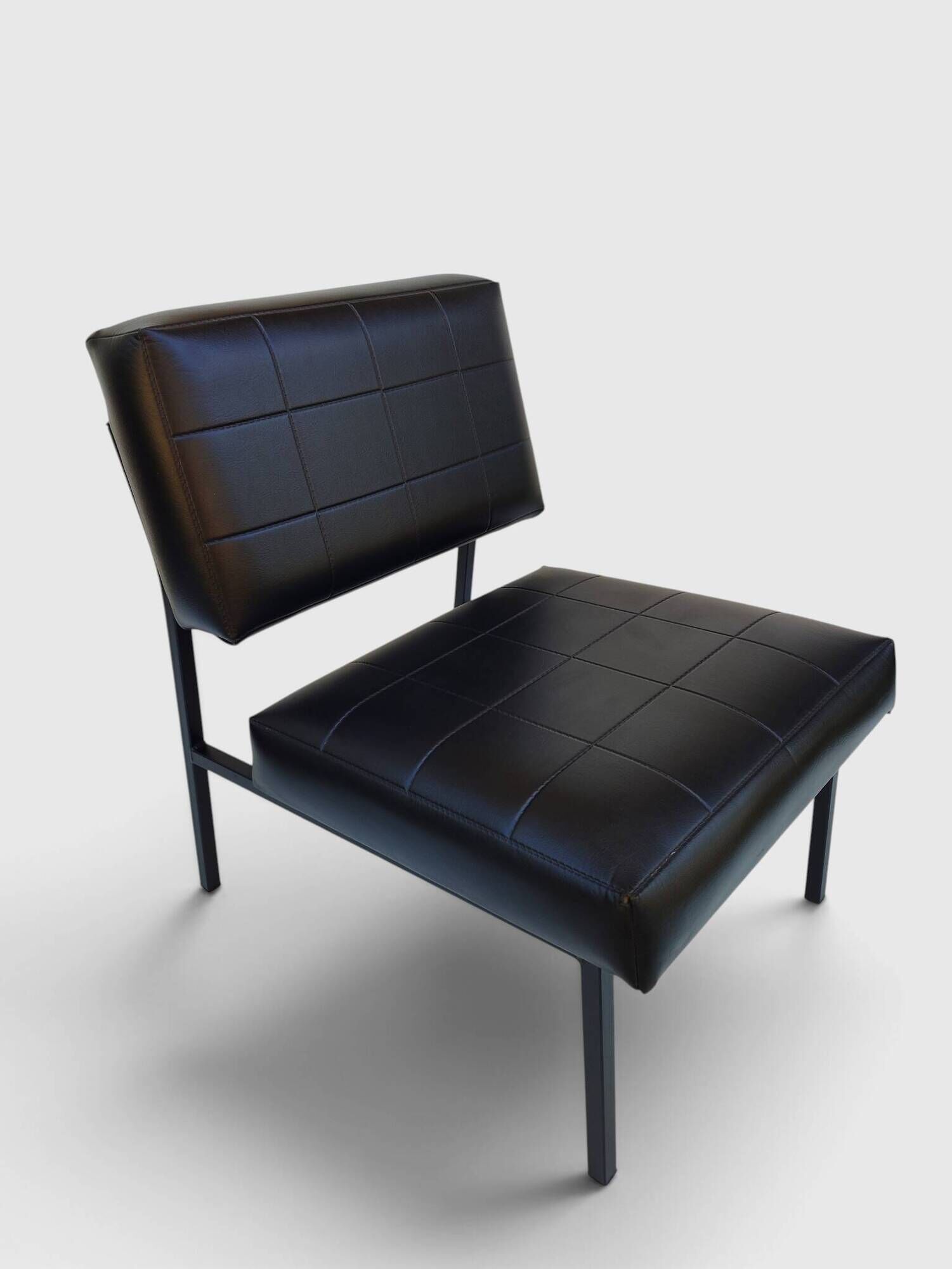Modernist armchair in black faux leather and metal – 1960s