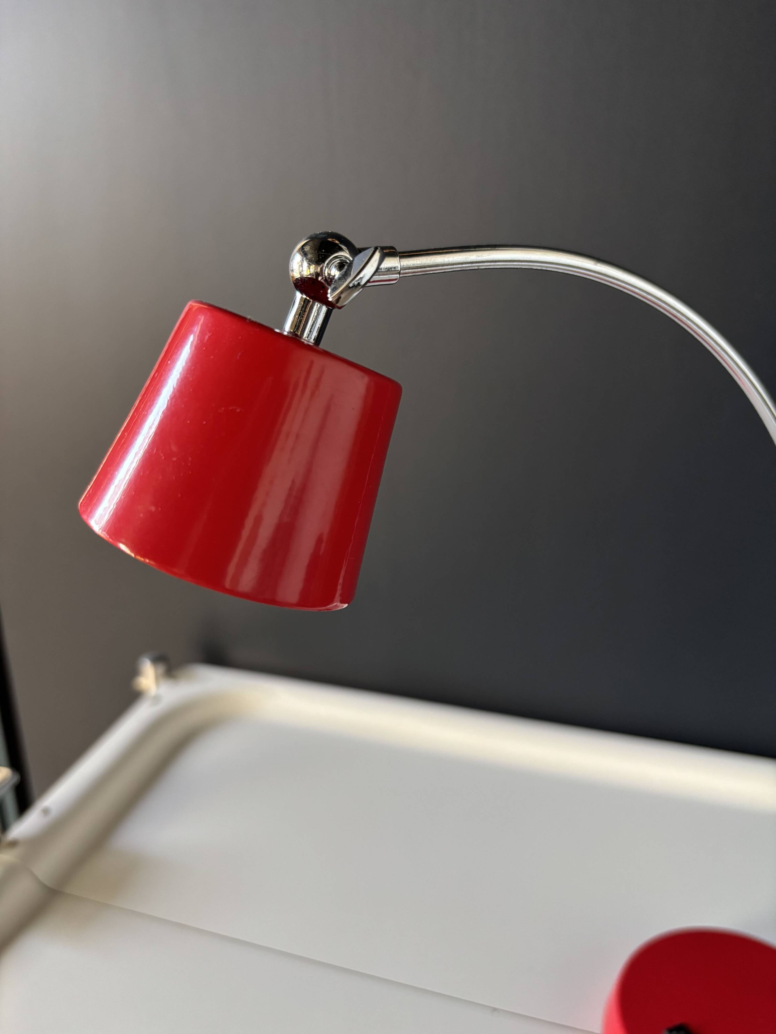 Vintage red lamp with a curved arm
