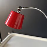 Vintage red lamp with a curved arm