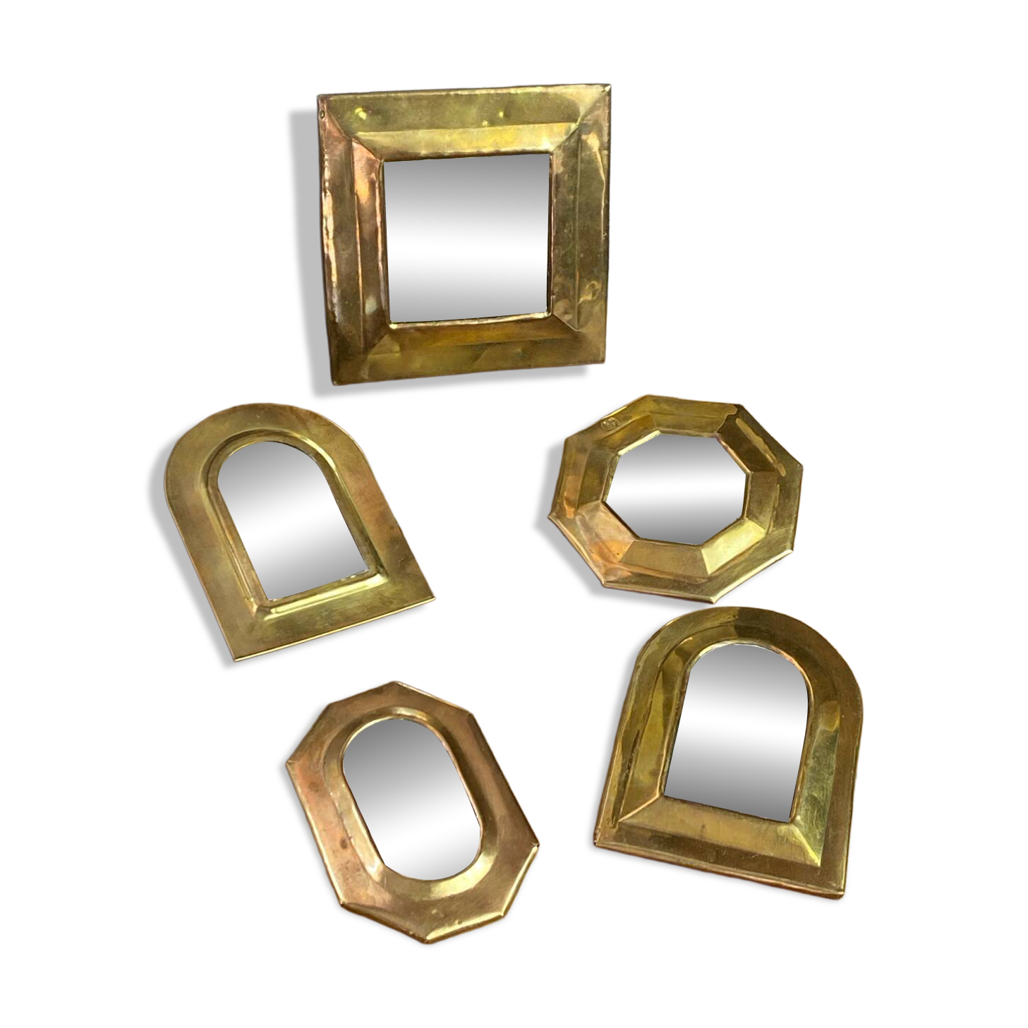 Set of five small wall mirrors in brass.