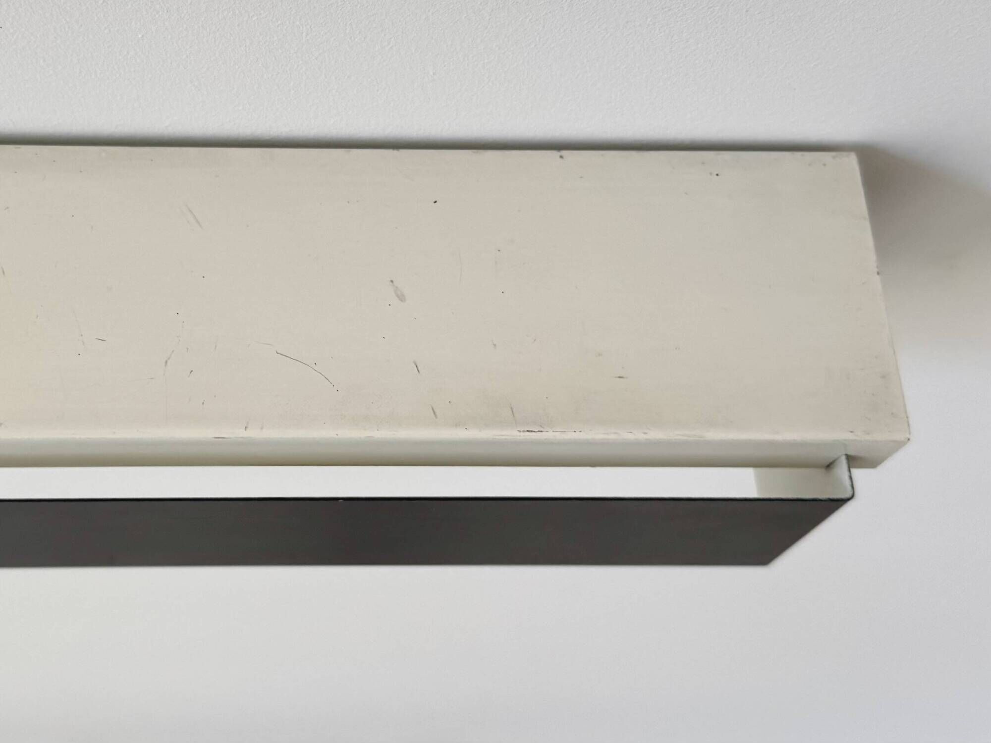 Pair of vintage wall sconces, painted black and white metal, Sweden 1970.