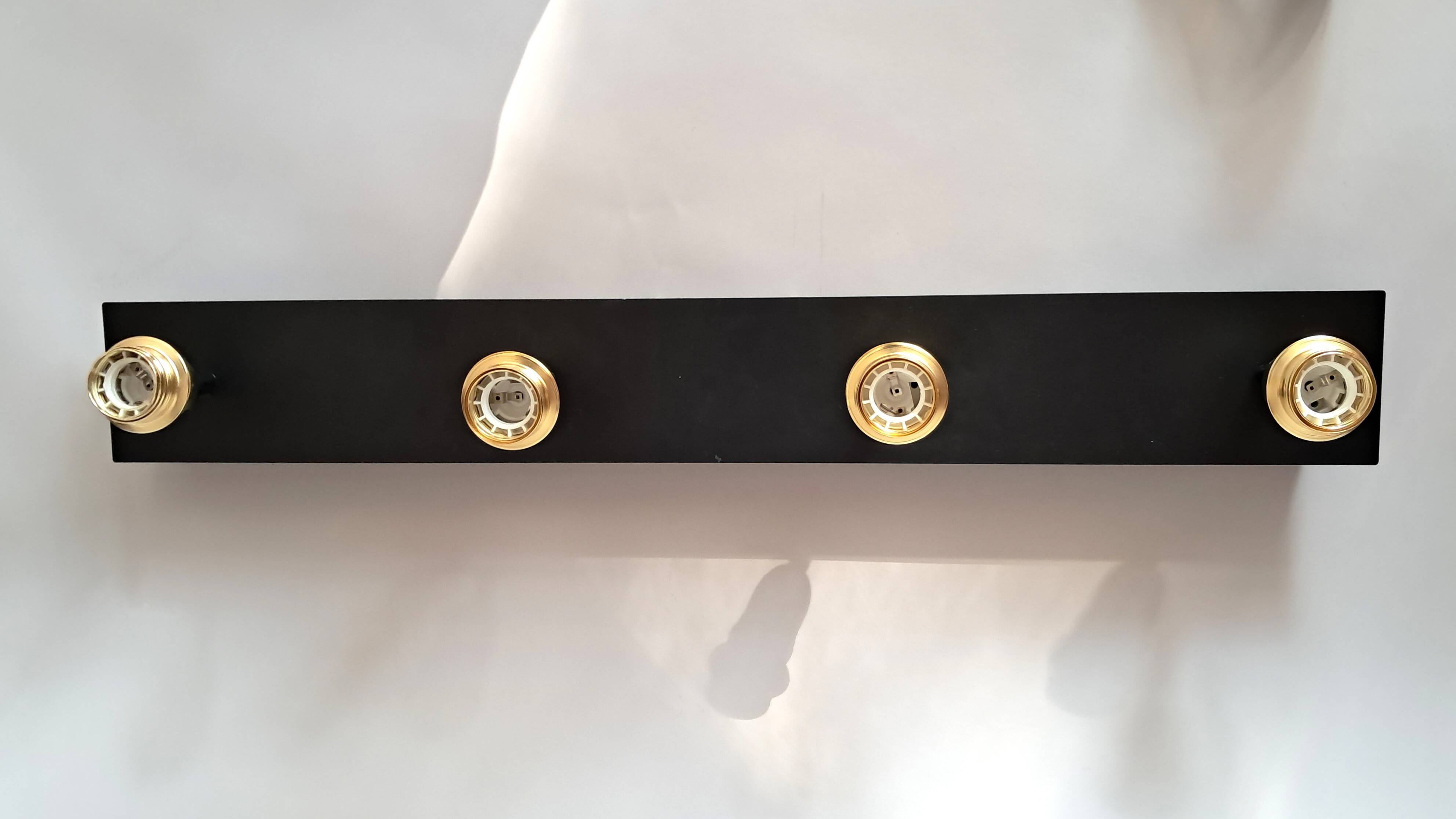 Wall lamp with 4 adjustable lights in black metal and gold-plated brass sockets.