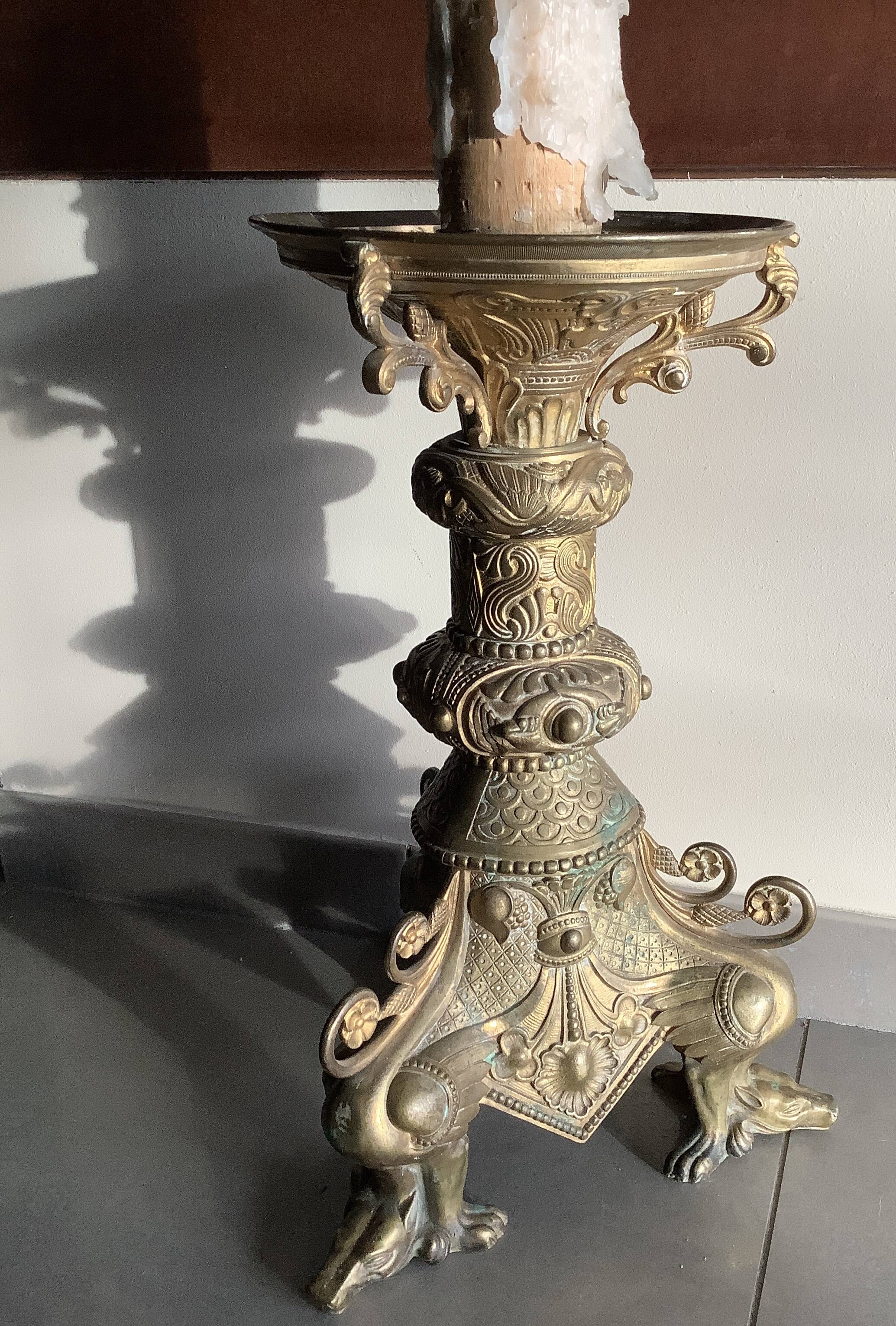 Large bronze candlestick with tripod and winged dog decoration, 19th century.
