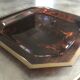 Tray in lucite imitation tortoiseshell and hexagonal brass strap
