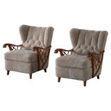 Pair of modern Swedish lounge chairs, shearling sheepskin and elm, 1940s.