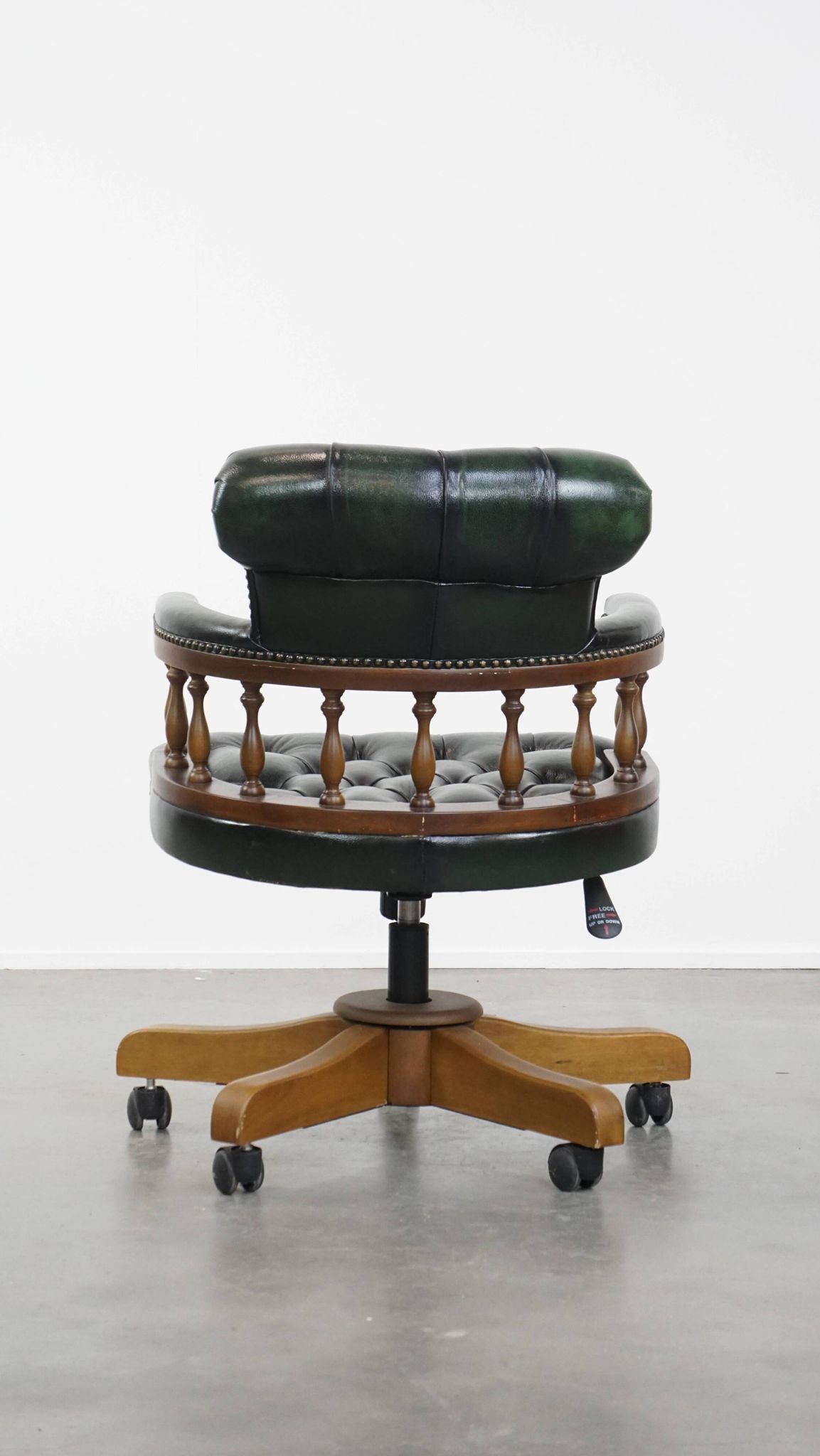 Dark green cowhide leather and wood chesterfield office chair on wheels