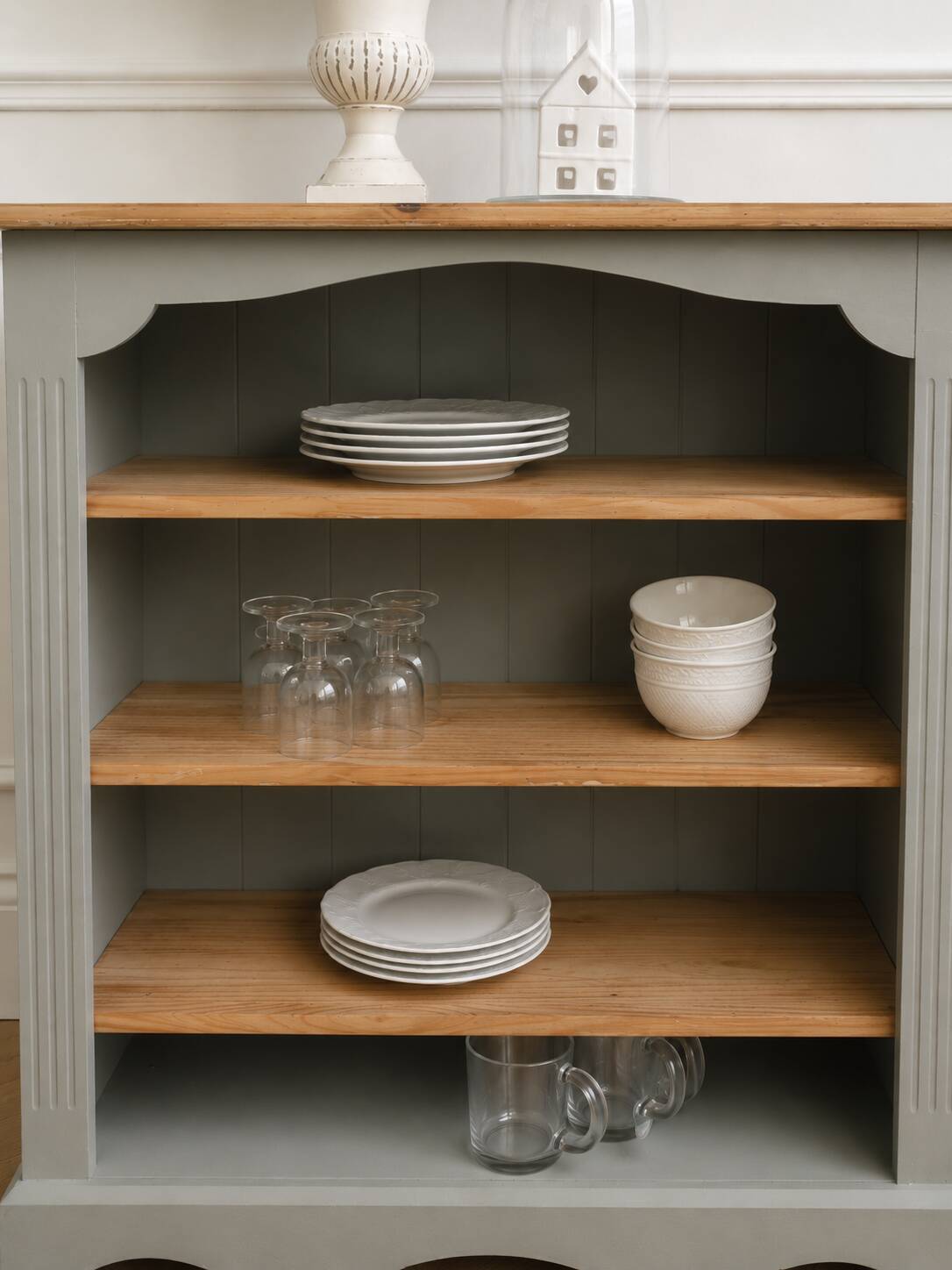 Green-grey library, wooden shelf and shelves in natural wood.