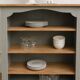 Green-grey library, wooden shelf and shelves in natural wood.