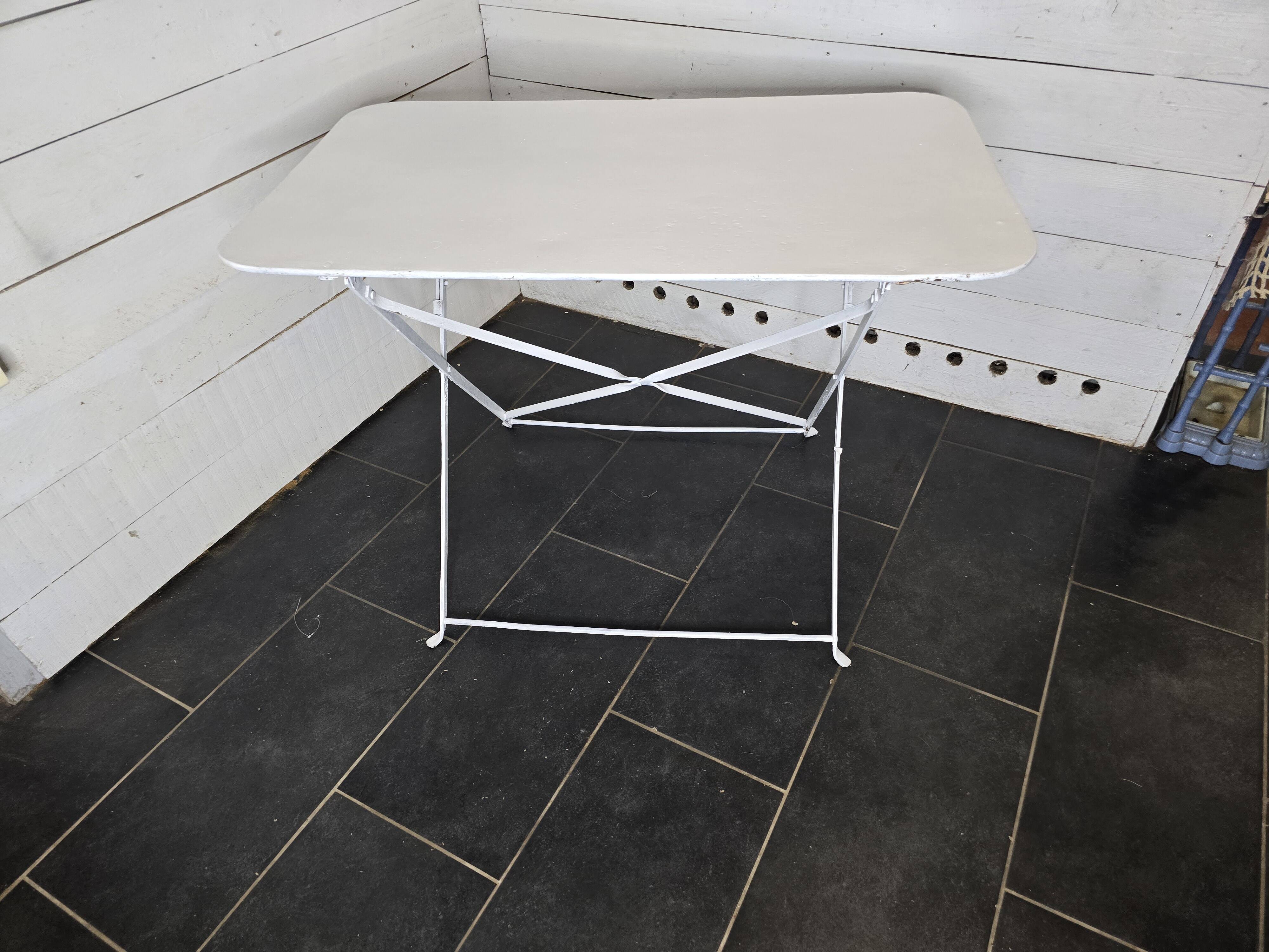 Old folding wrought iron garden table