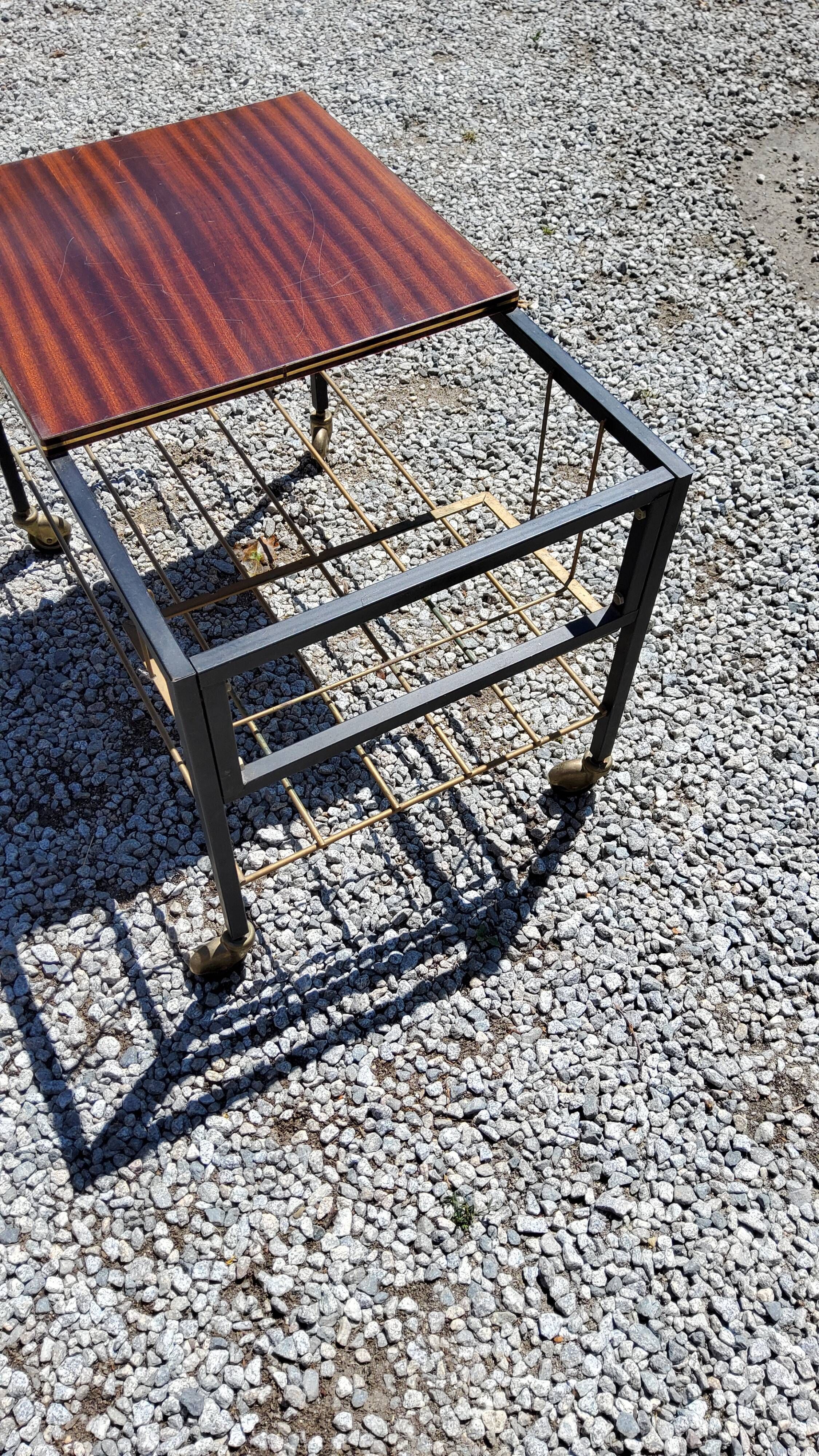 Coffee table from the 60s in black and gold metal tubes mahogany formica top
