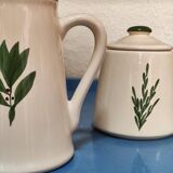 White ceramic pot and mini pitcher with bay leaf illustration