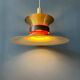 Large UFO flying saucer pendant light with orange light.