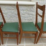 6 modern chairs with banded backs and green faux leather seats