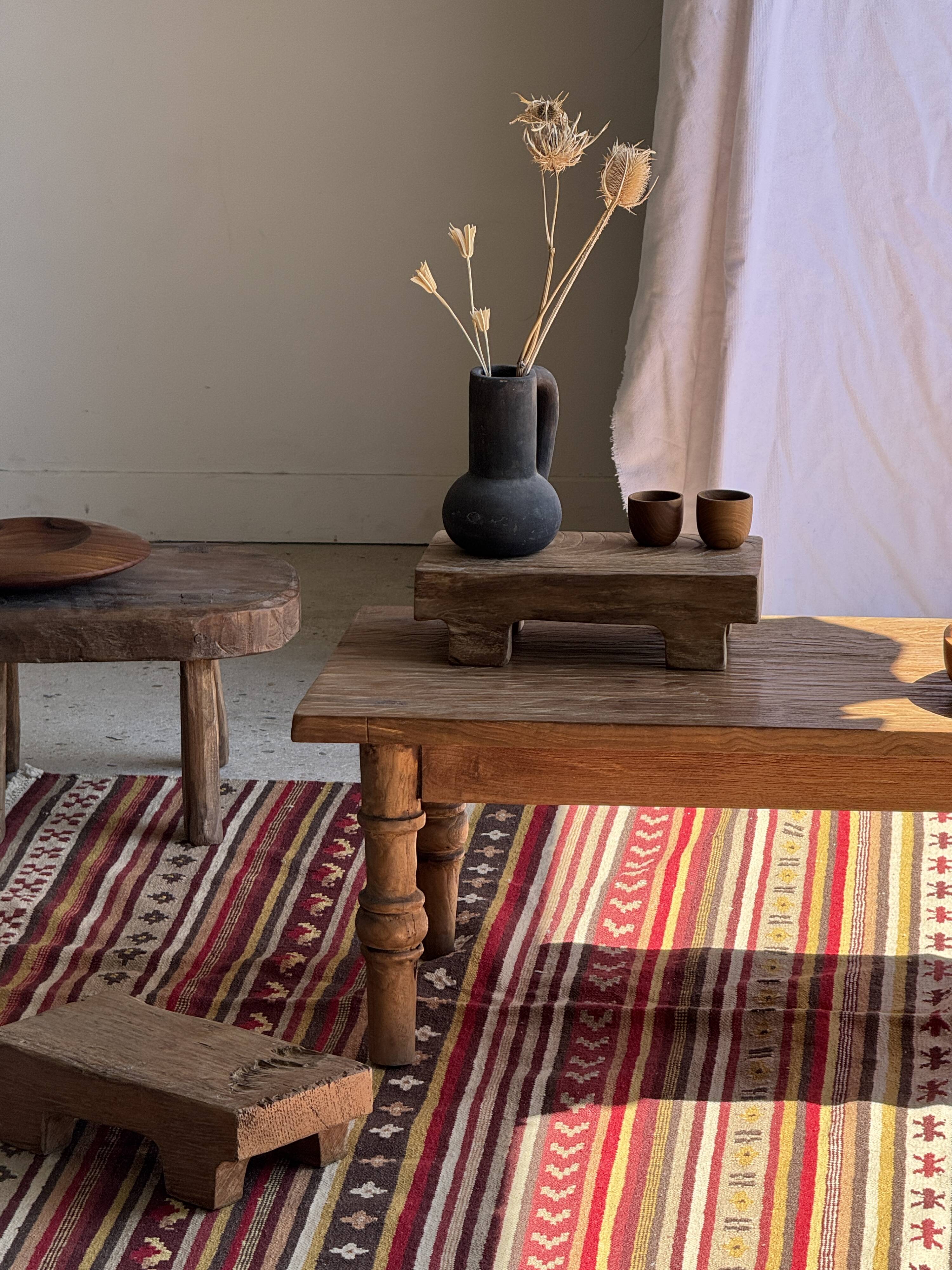 Large Indian rug with red, yellow, and white stripes and geometric fringes.