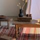 Large Indian rug with red, yellow, and white stripes and geometric fringes.