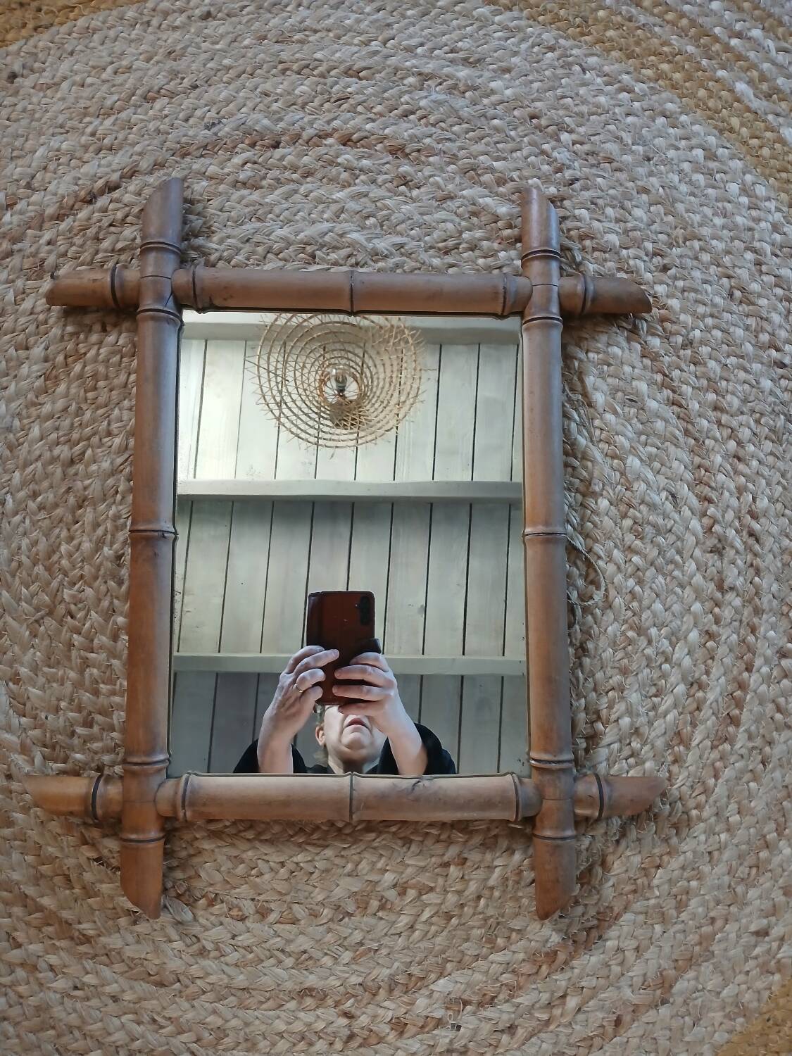 Antique wall mirror with a wooden frame