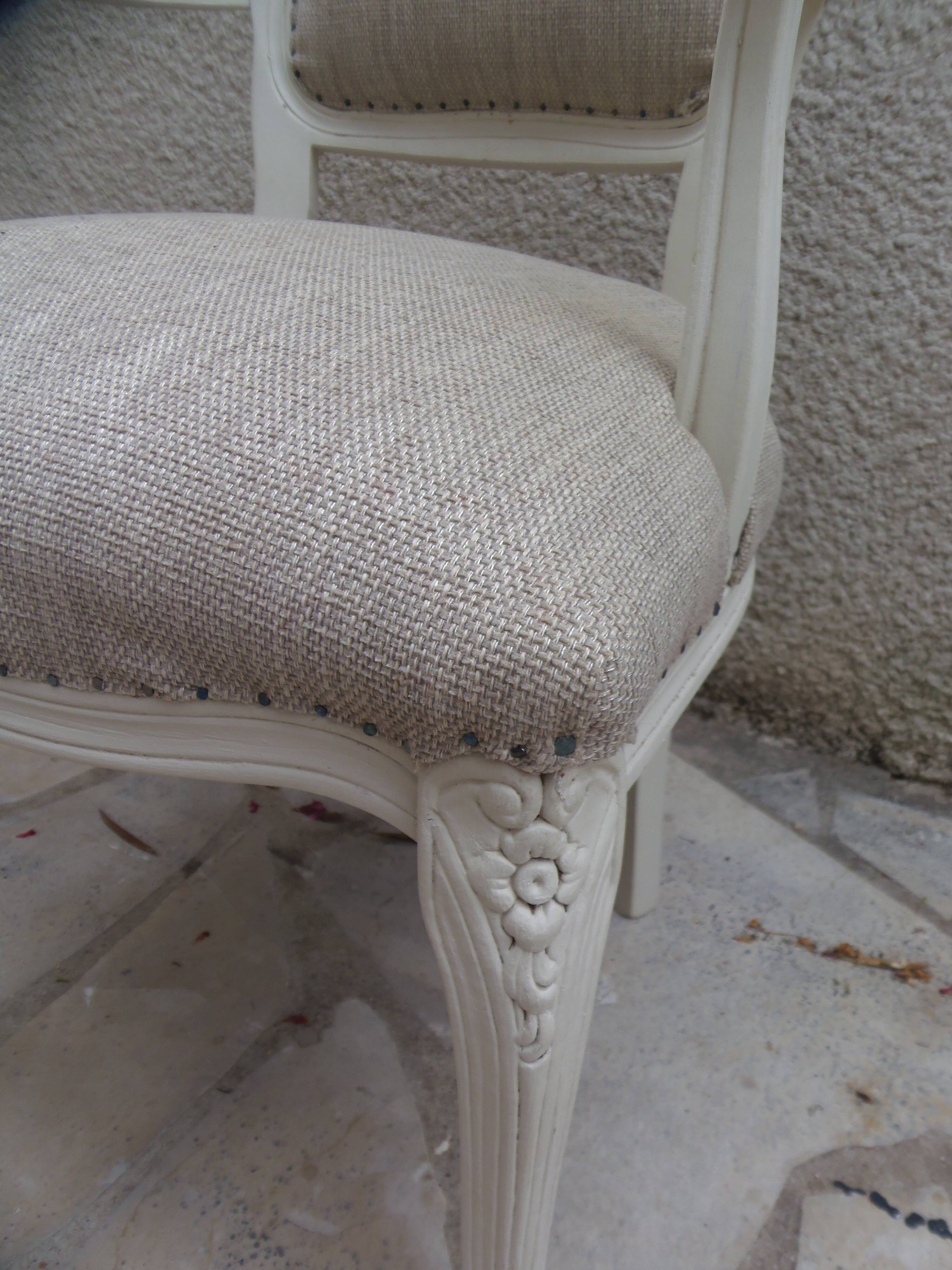 Louis XV style armchair in patinated beige, upholstered in beige fabric.