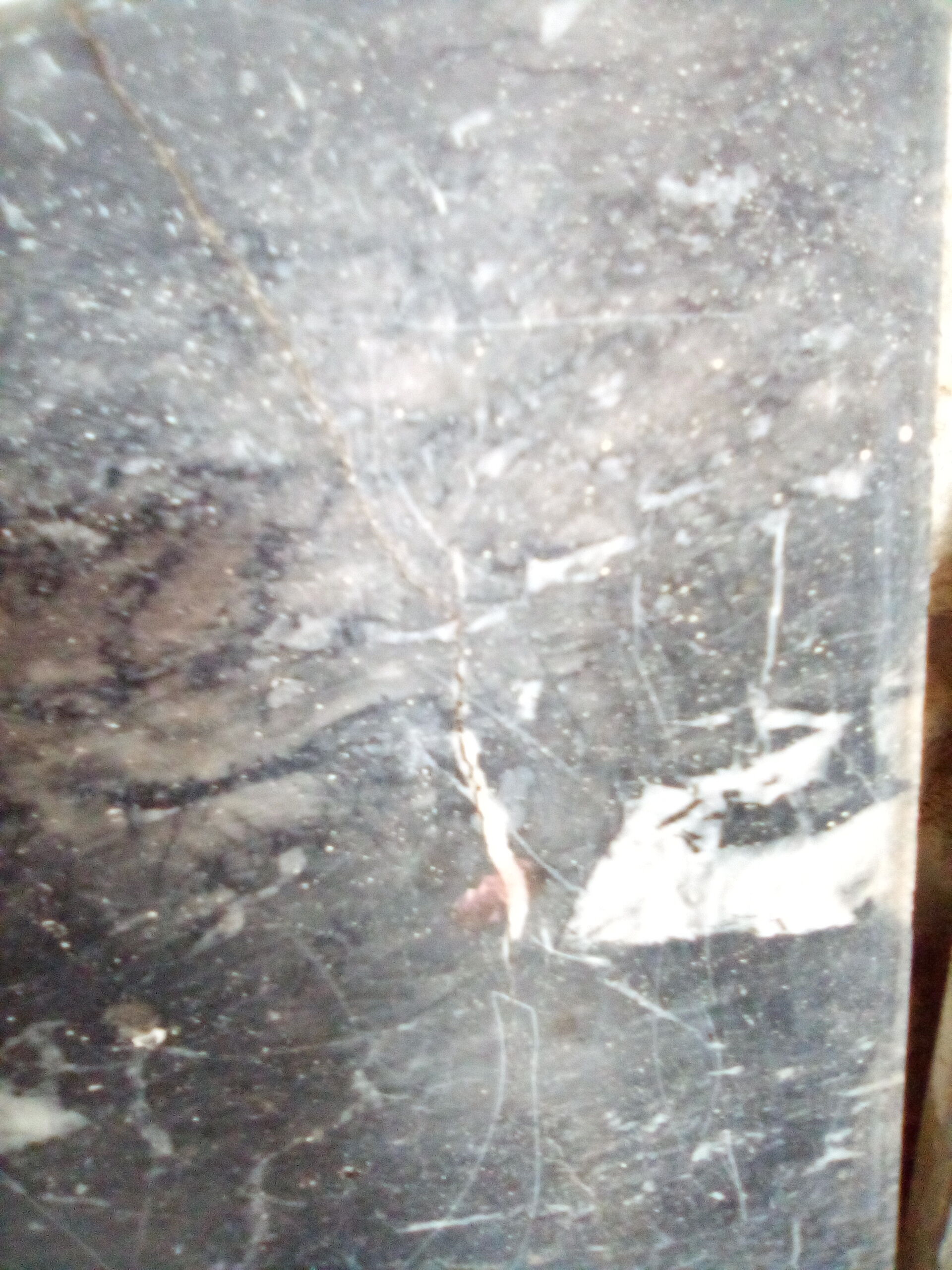 White veined black marble fireplace