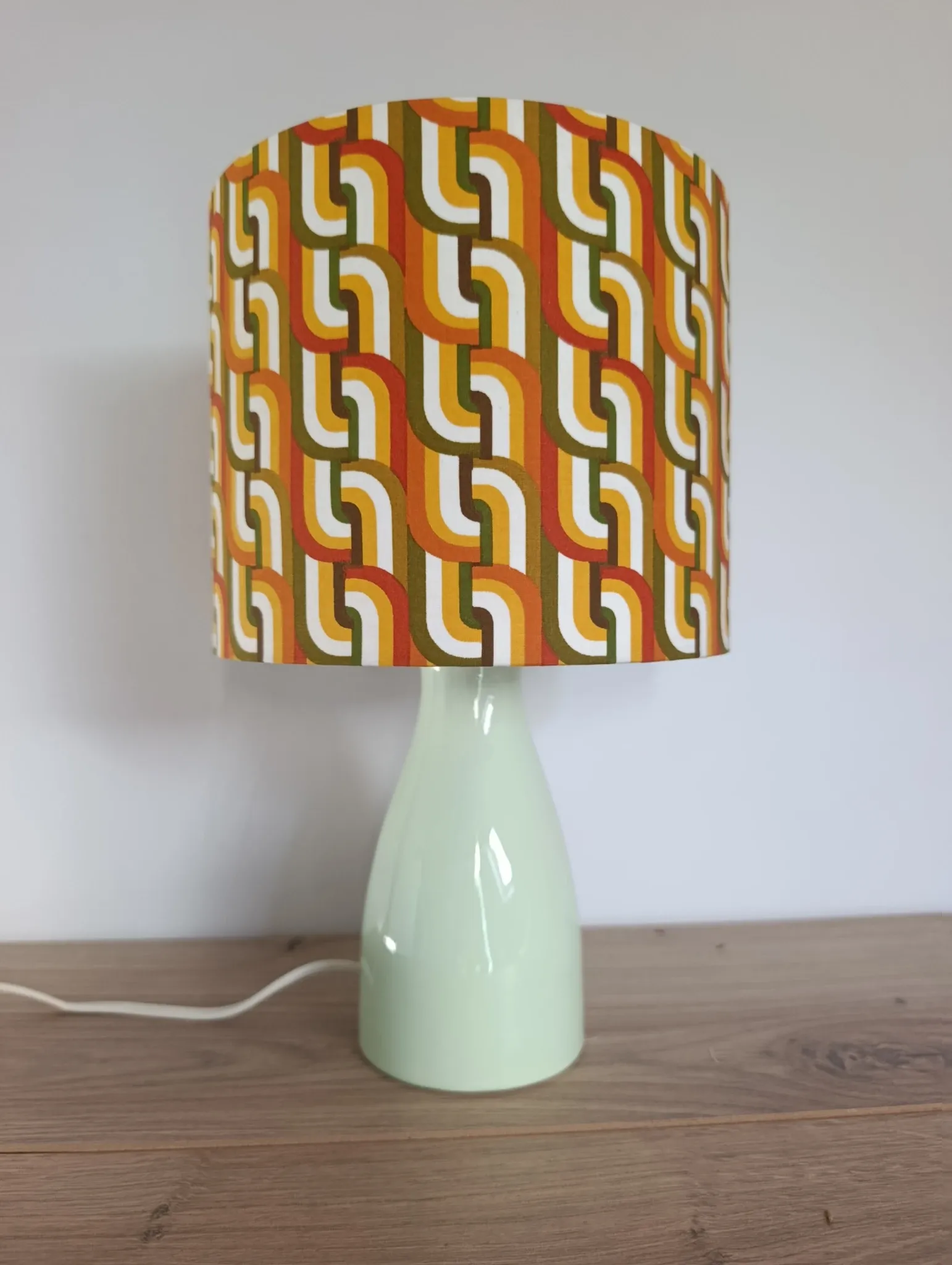 Seventies spirit lamp with geometric orange/green lampshade.
