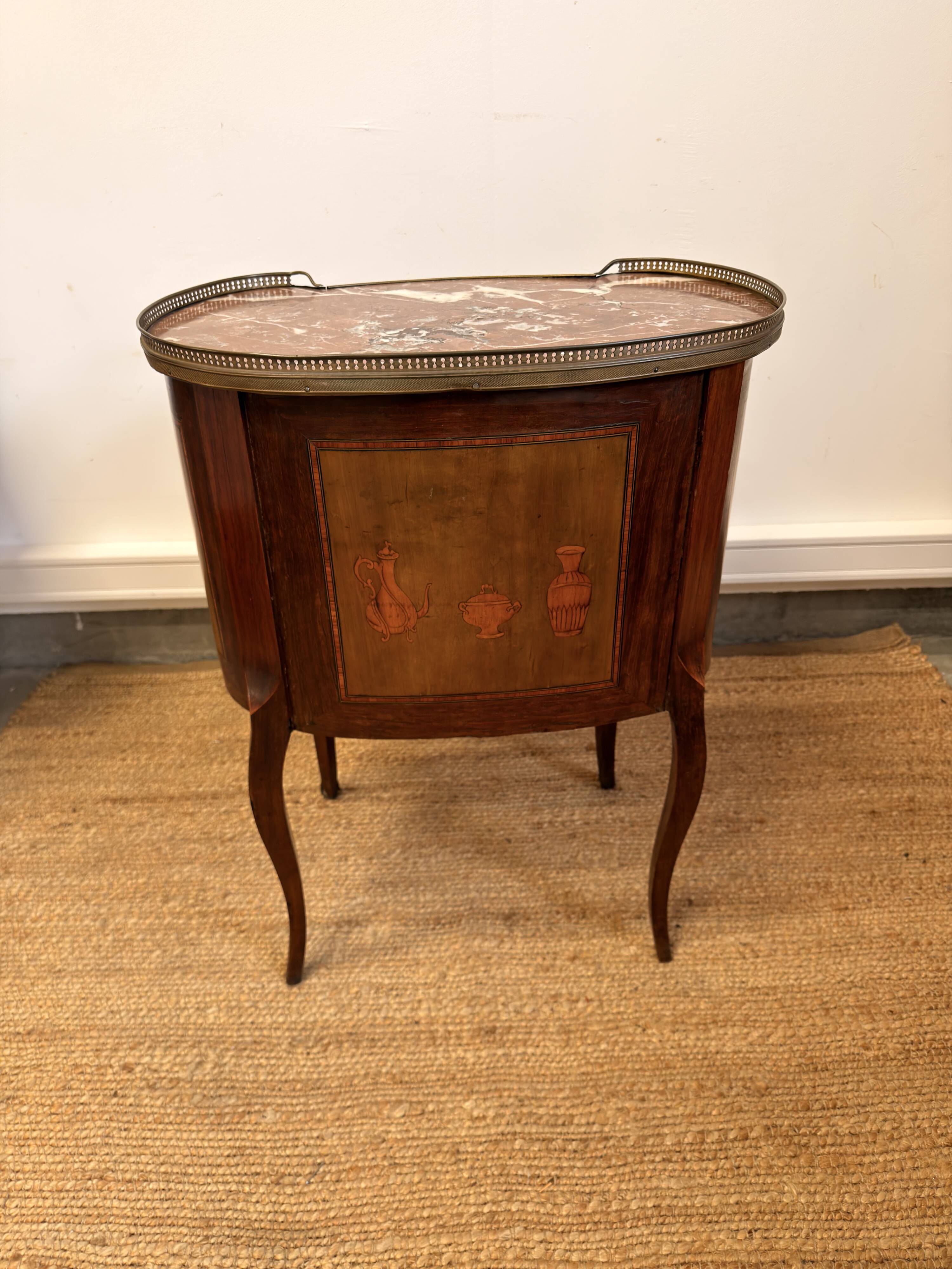 Transitional style side table, with a red marble top.