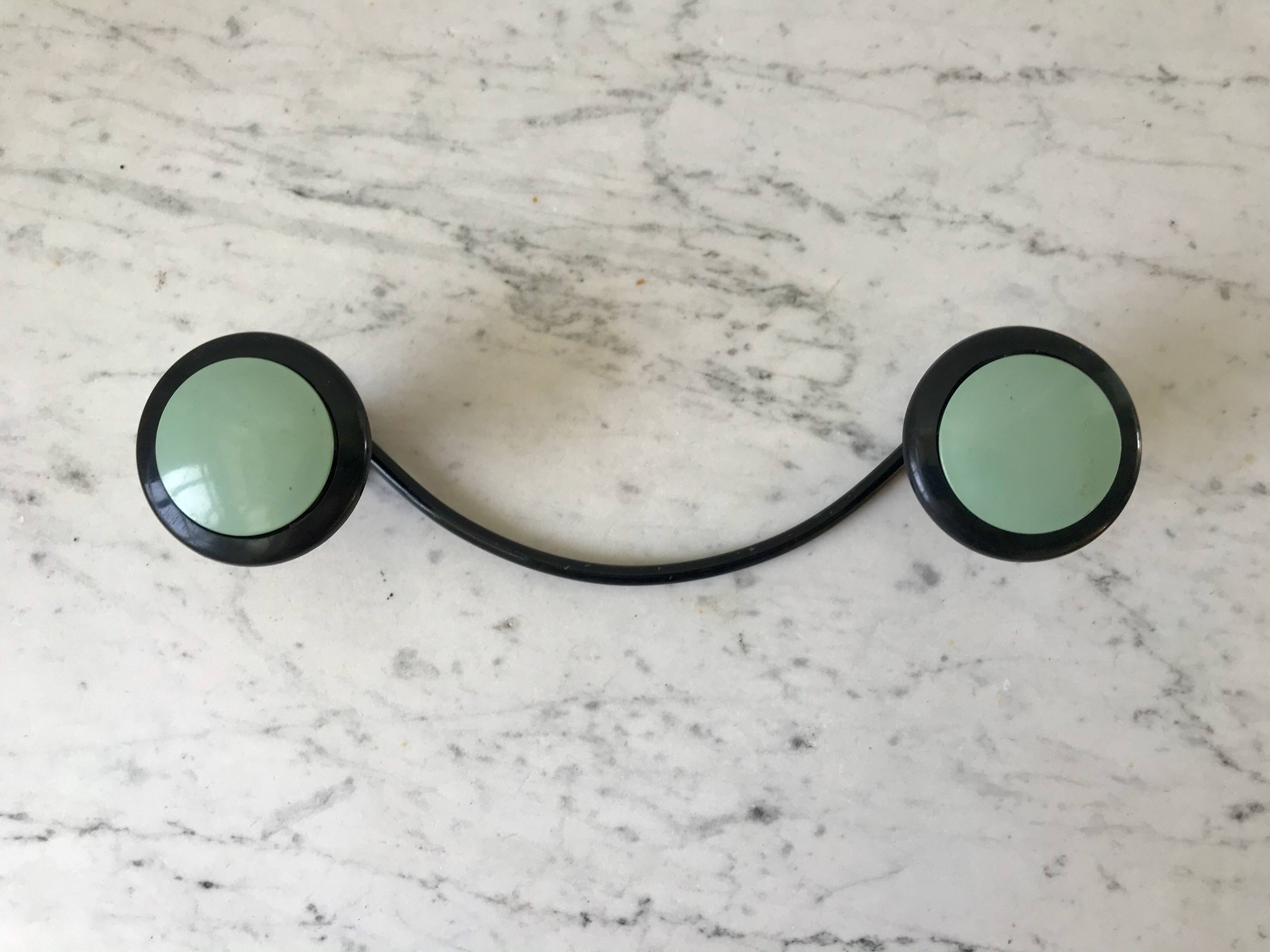 Design coat hook in sage green and black metal from the 70s