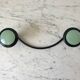 Design coat hook in sage green and black metal from the 70s