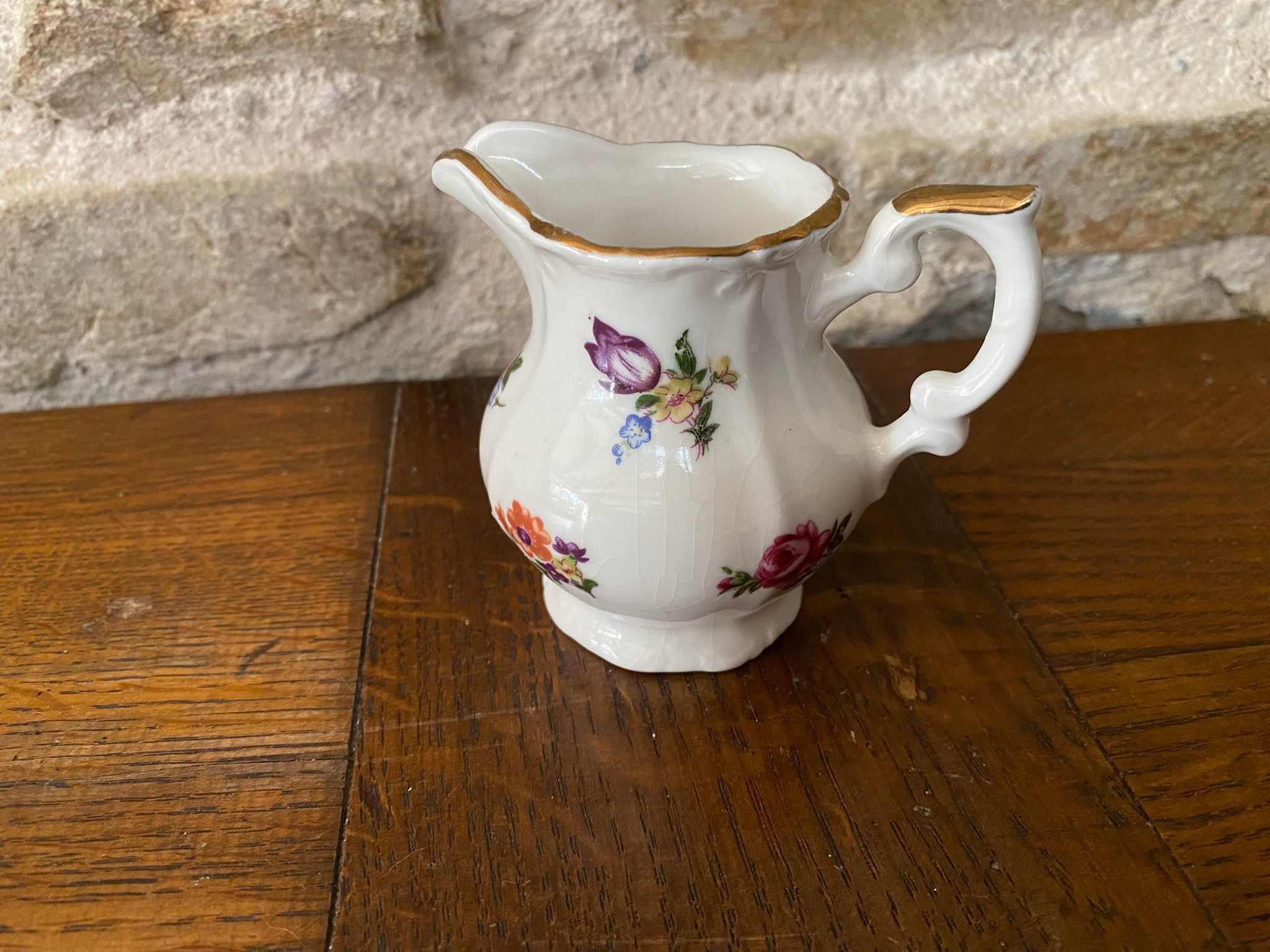 Small milk jug or creamer decoration flowers and golden edge