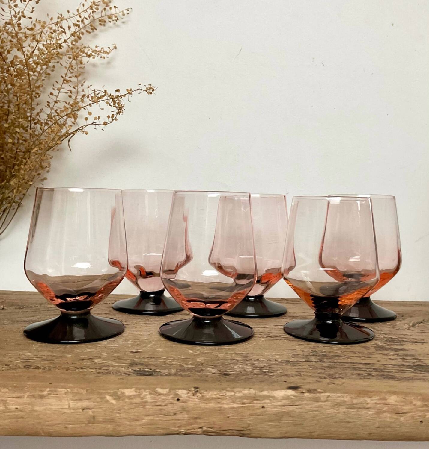 6 small pink glasses with black stems