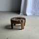 Small low circular four-legged stool in organic old teak with cut-out design H2