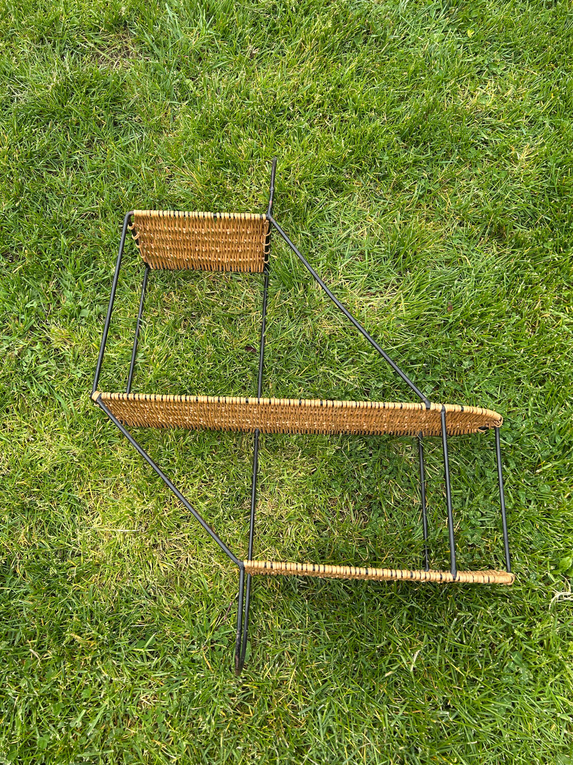 Wall shelf made of rattan and wrought iron