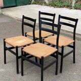 4 black Scandinavian chairs with solid wood and cord.
