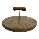 Vintage round wooden cheese board covered with glass plate with foldable handle