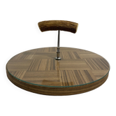 Vintage round wooden cheese board covered with glass plate with foldable handle