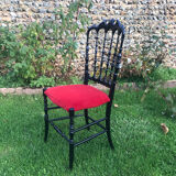 4 black reception chairs with red seats