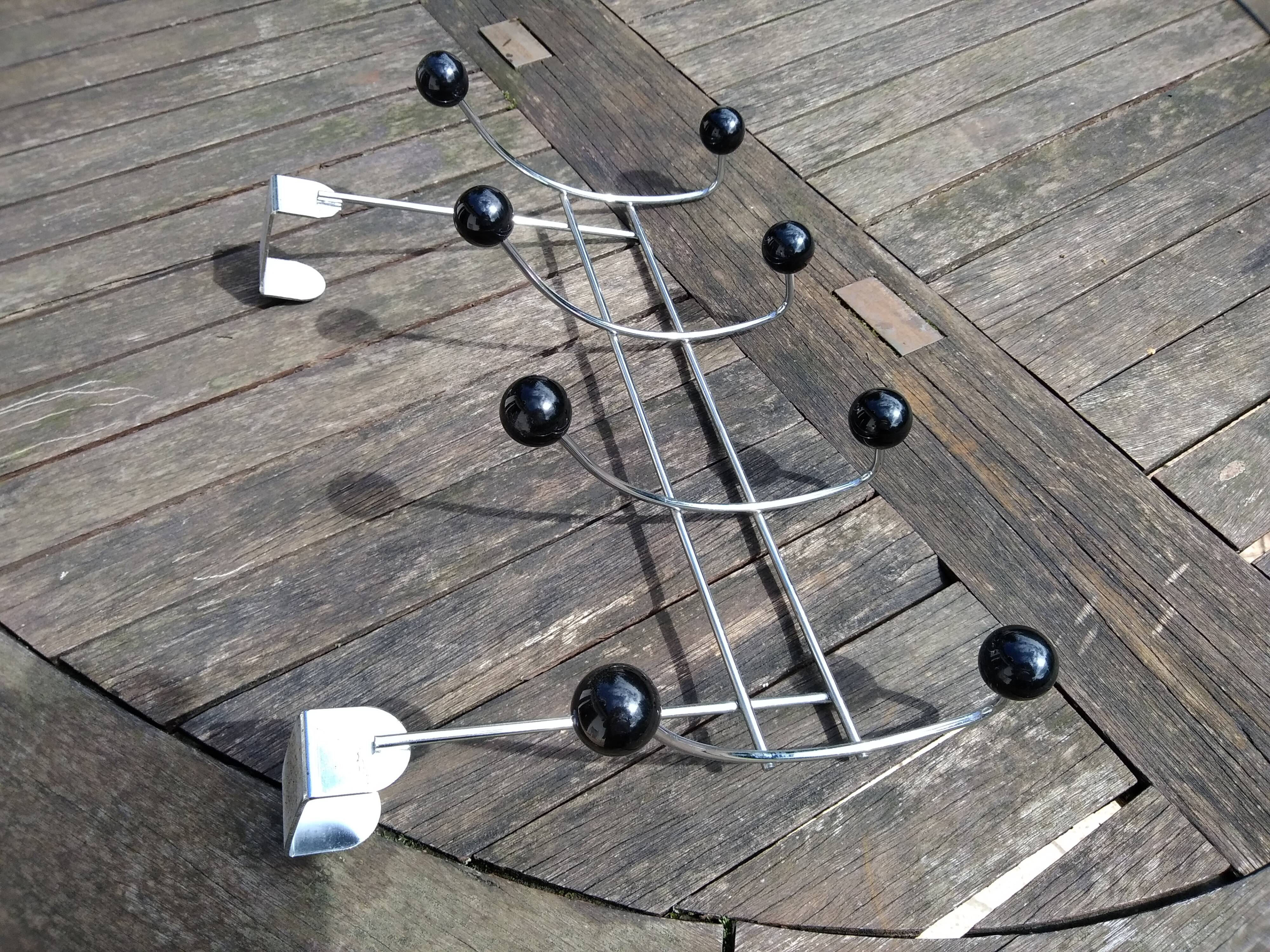 Coat rack that hangs at the top of a door