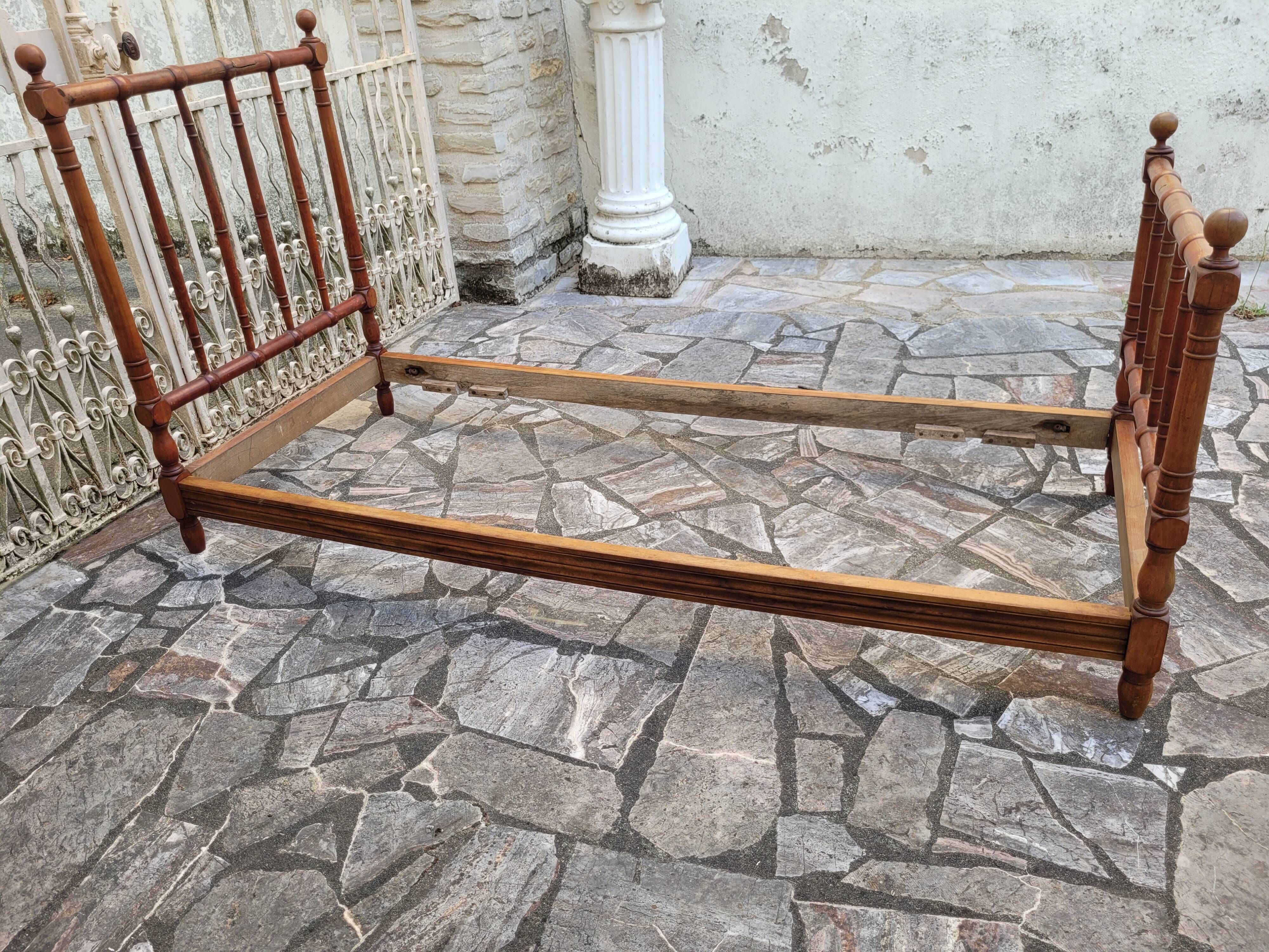 Child's bed or vintage rest bed made of solid cherry wood in a bamboo style.