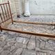 Child's bed or vintage rest bed made of solid cherry wood in a bamboo style.