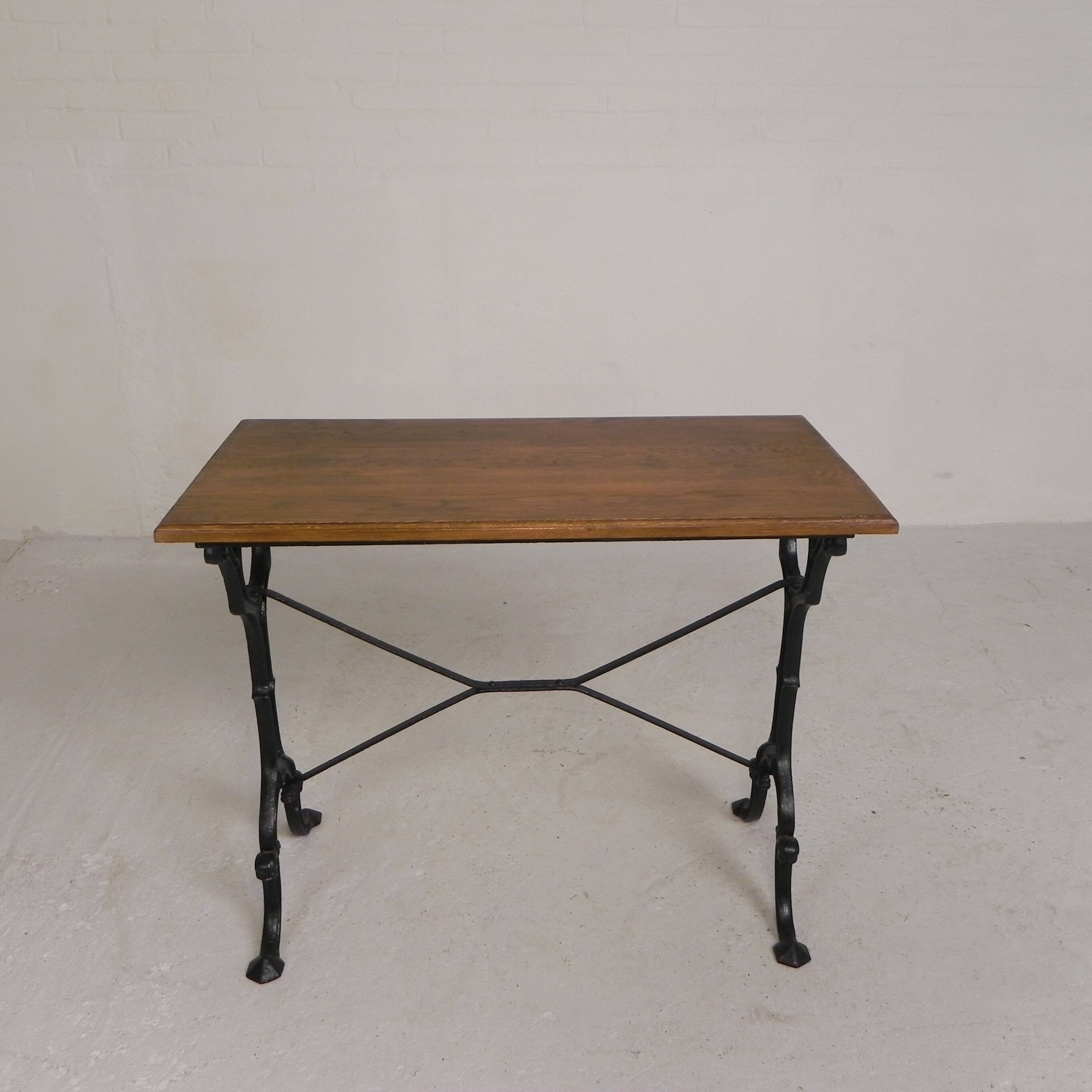 Bistro table with an oak top on a cast iron base, 1930s.
