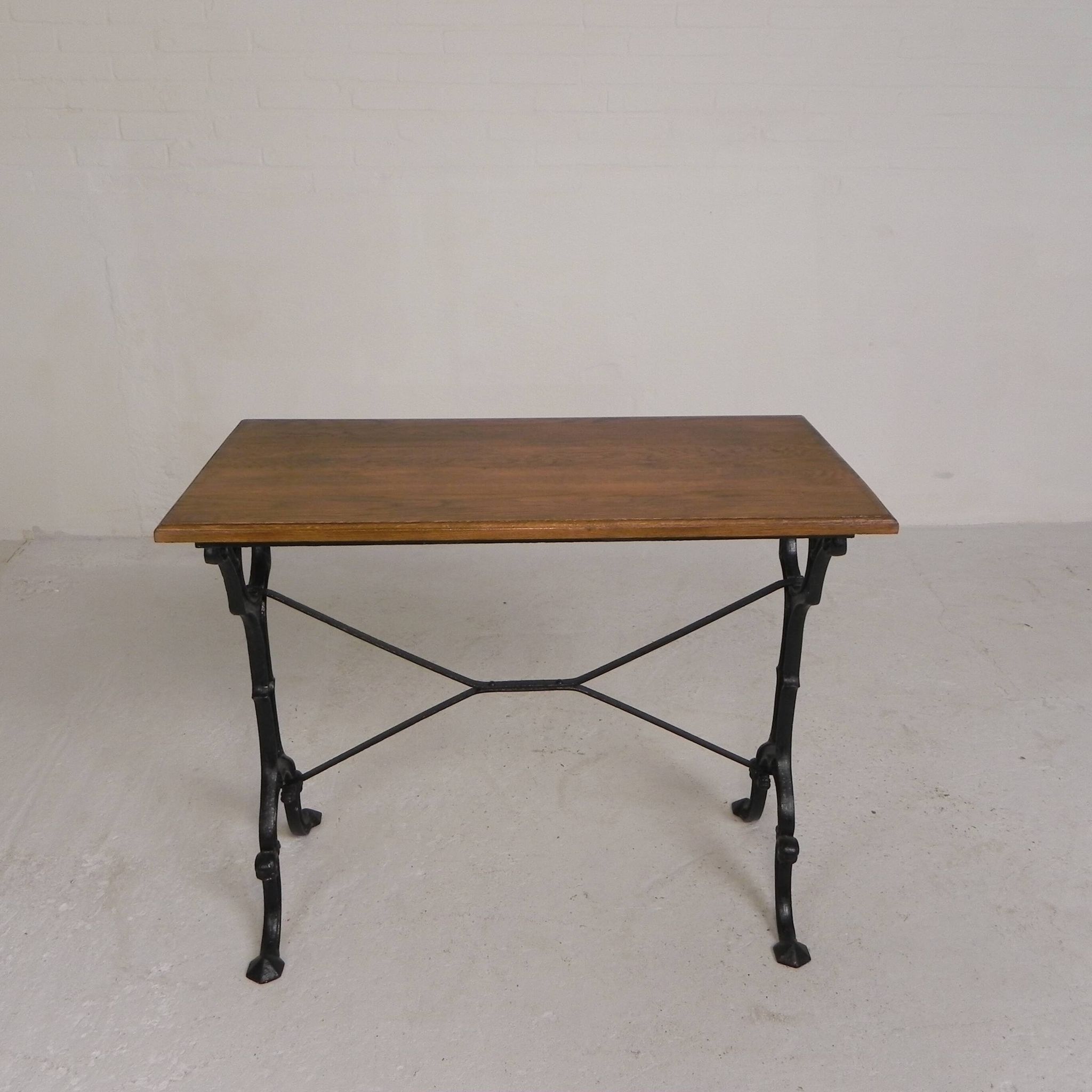 Bistro table with an oak top on a cast iron base, 1930s.