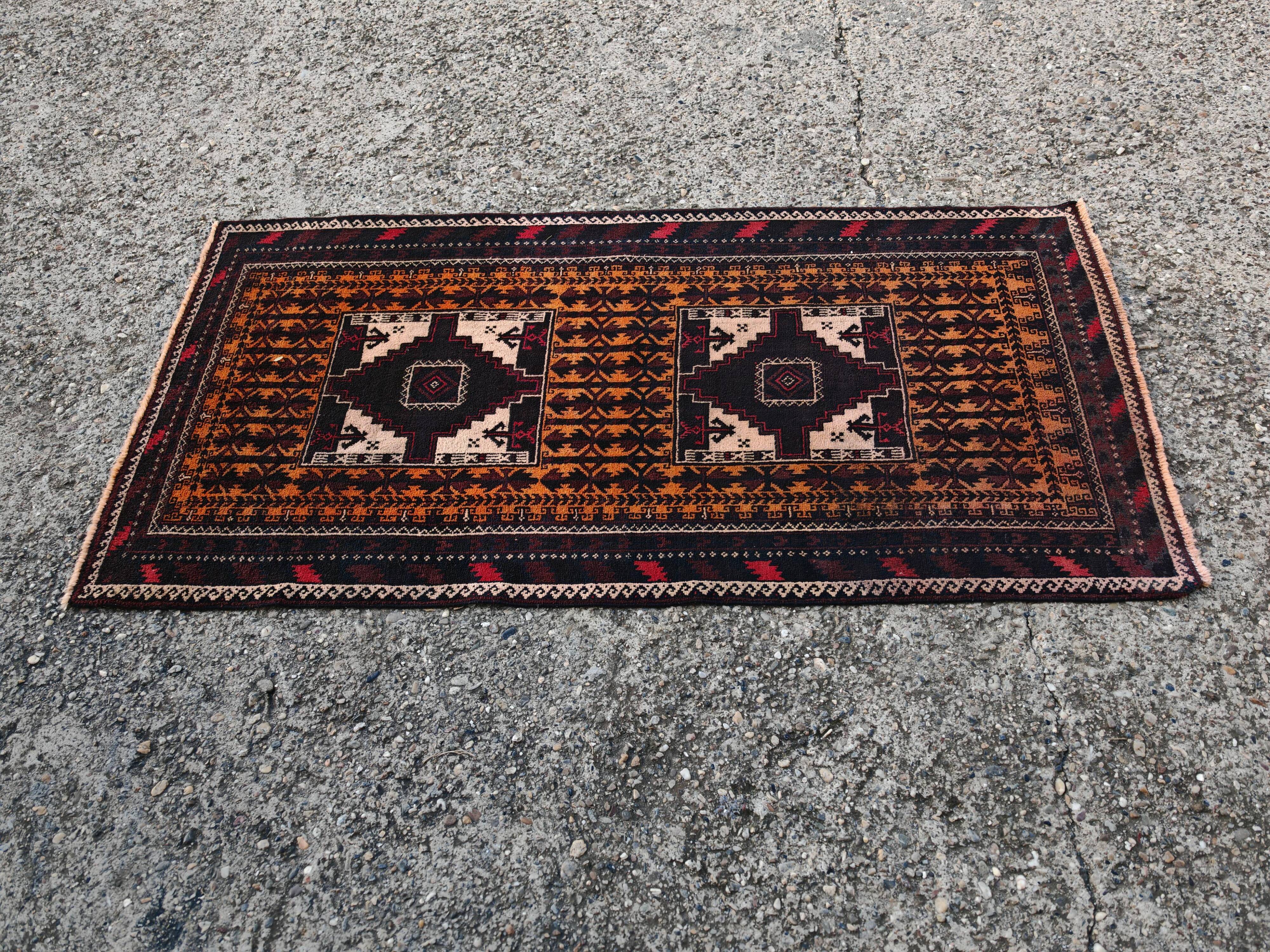 Vintage Persian Baluch rug, hand-knotted wool, 1970.