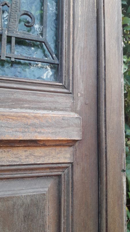 Oak entrance door and its frame and transom, wrought iron gates